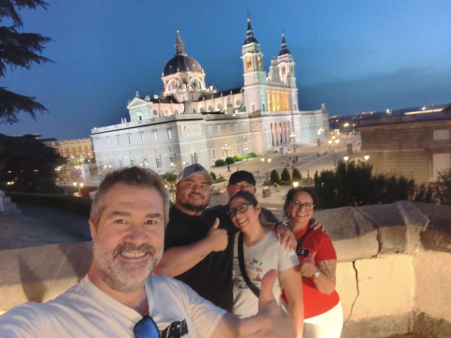Happy group on a Tuk Tuk tour in front of the Almudena Cathedral, Madrid