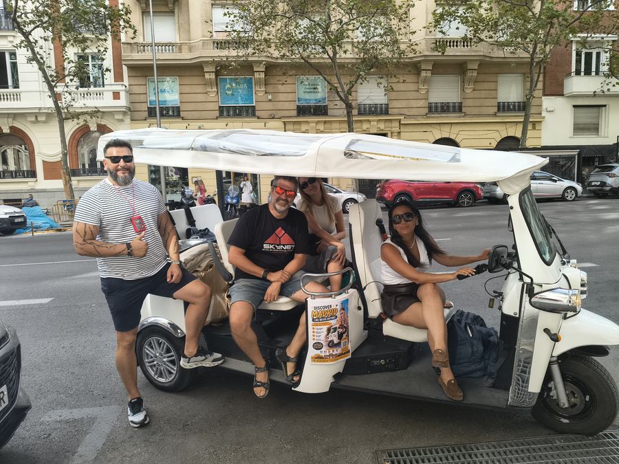 Tourists on a private Tuk Tuk tour near Cibeles, Madrid