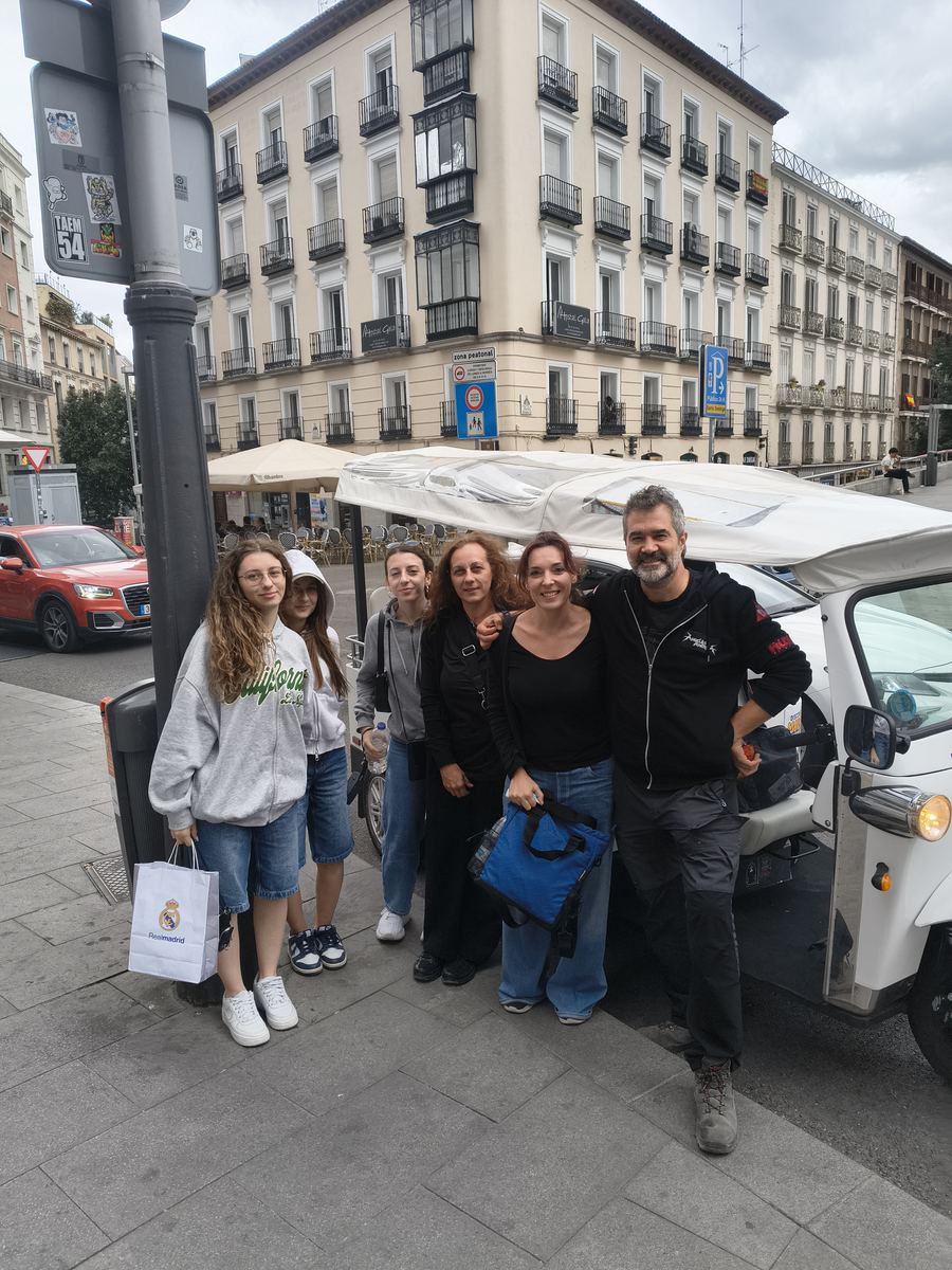 Family enjoying a Tuk Tuk tour on Calle de Cervantes, Madrid