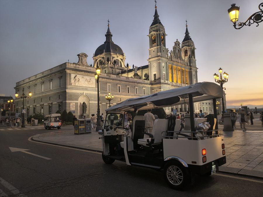 Tuk Tuk parked in front of the Almudena Cathedral at dusk, Madrid
